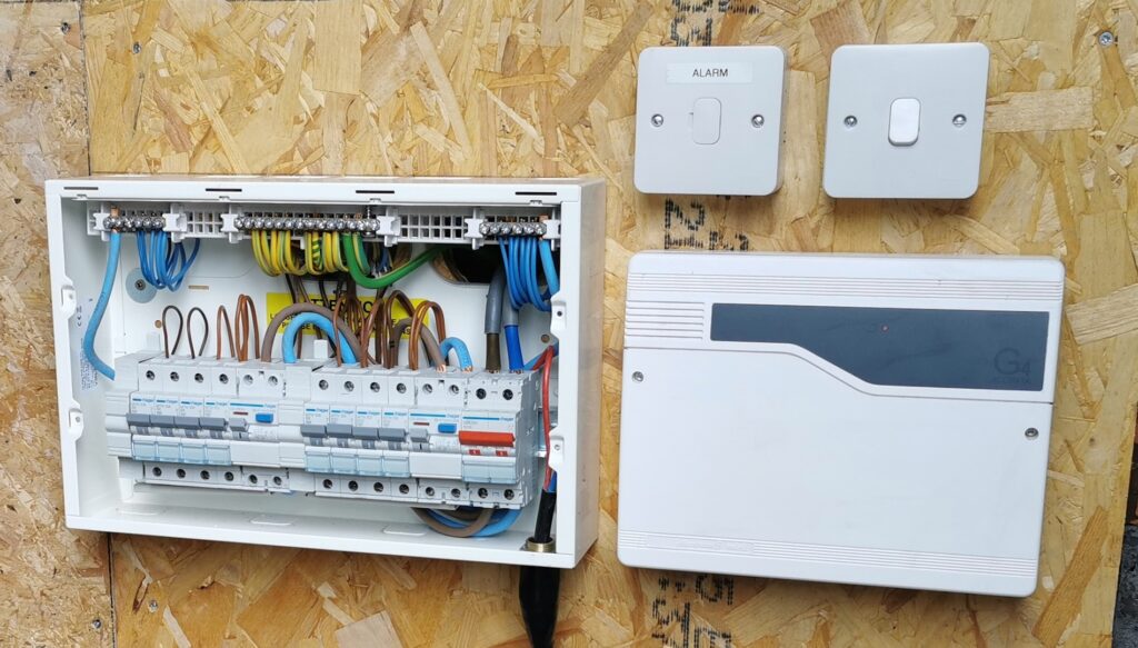 Consumer unit and sockets wired onto a board during an electrical installation